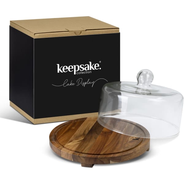 A glass cake display dome with a wooden base, packaged in a black box featuring a logo.