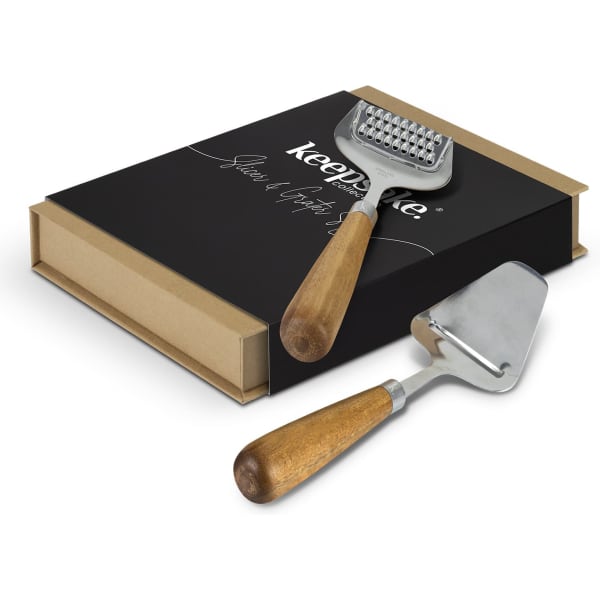 A slicer and grater set with wooden handles and a black presentation box featuring a logo.