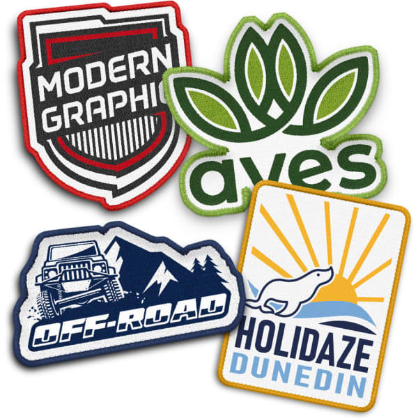 A selection of four custom woven patches in various shapes and colours, featuring logos and designs.