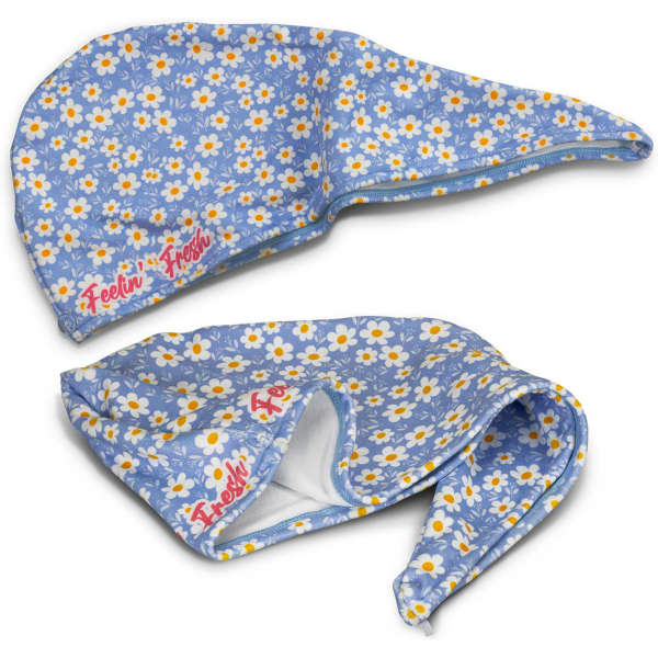 A blue floral hair towel with a pointed hood and a logo, featuring white daisies and yellow accents.