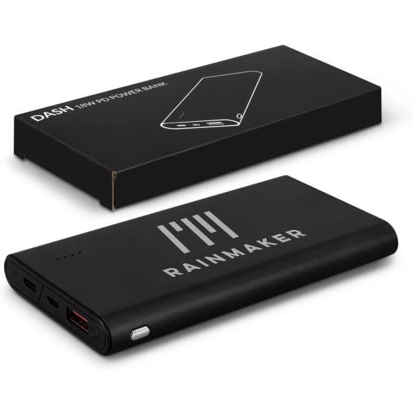 A black power bank with a logo, placed next to its packaging. It features multiple USB ports.