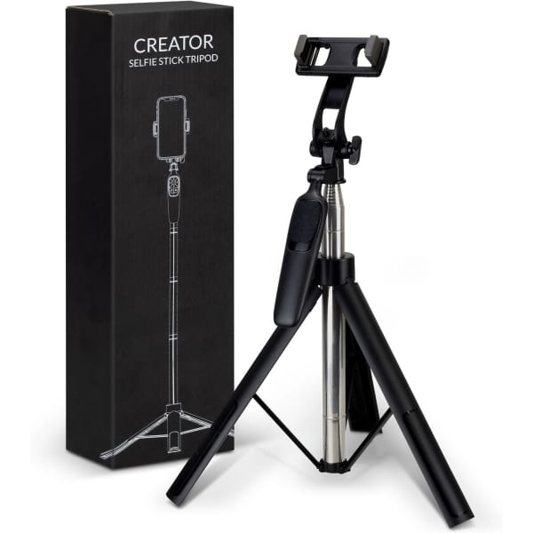 A black selfie stick tripod with a phone holder, next to its packaging, also in black.