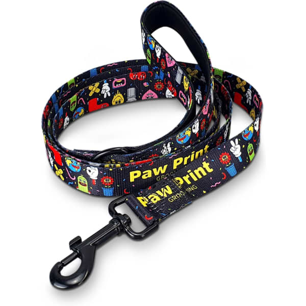 A dog leash featuring a vibrant pattern of cartoonish designs, primarily in black with colourful prints and a clip attachment.
