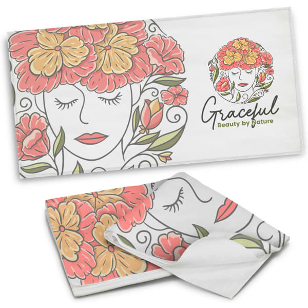 A full-colour beach towel featuring a floral design with red, orange, and green elements. It has a logo present.