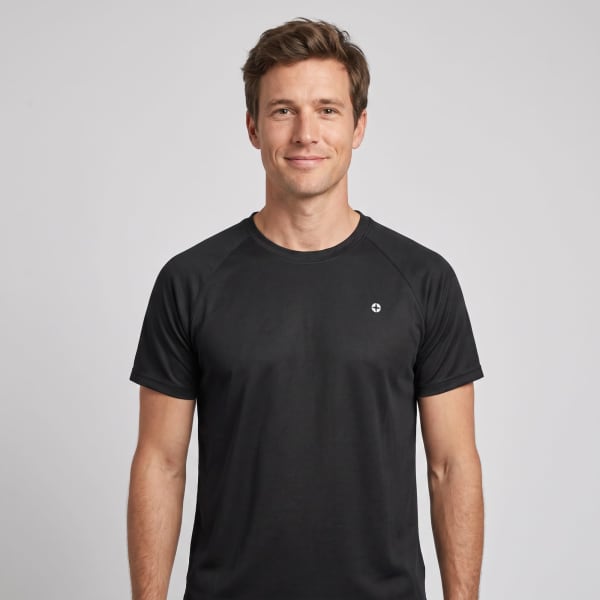 A black t-shirt featuring a logo, worn by a smiling man against a plain background.