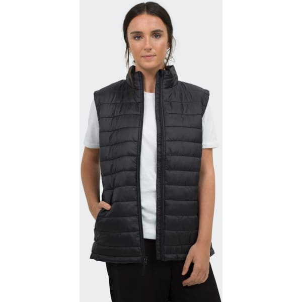 A woman wearing a black puffer vest over a white t-shirt, featuring a zipper and side pockets.