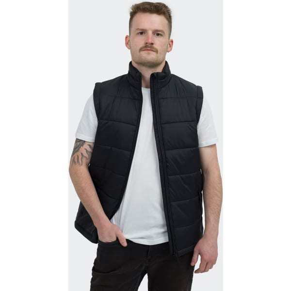 A black puffer vest with a high collar, worn by a person standing with hands in pockets.