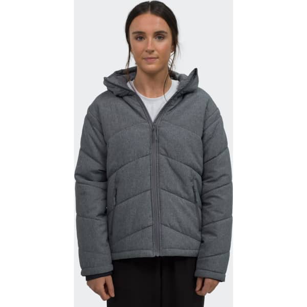 A grey puffer jacket with a hood, featuring a zip front and a quilted design. The model is wearing it.