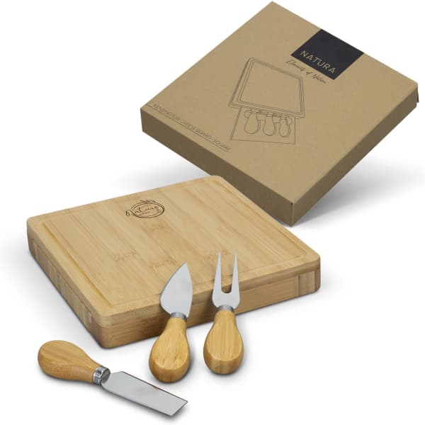 A square bamboo cheese board with three wooden-handled cheese knives, presented in eco-friendly packaging.