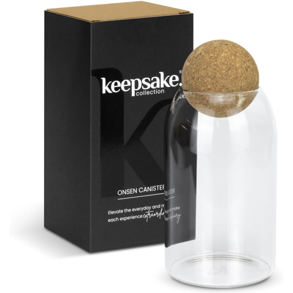 A glass canister with a cork lid, presented with a black box featuring a logo.
