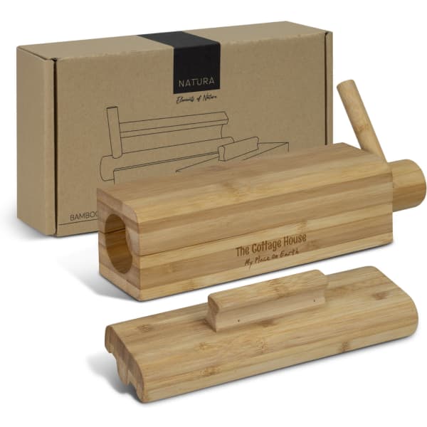A bamboo sushi maker with a wooden lid and a removable piece, presented with a decorative box.