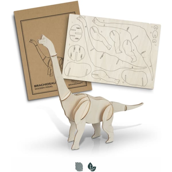 A wooden model of a Brachiosaurus in natural wood colour, alongside its cardboard packaging and assembly pieces.