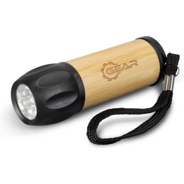 A bamboo torch with a black end and a wrist strap, featuring a logo on the wooden body.