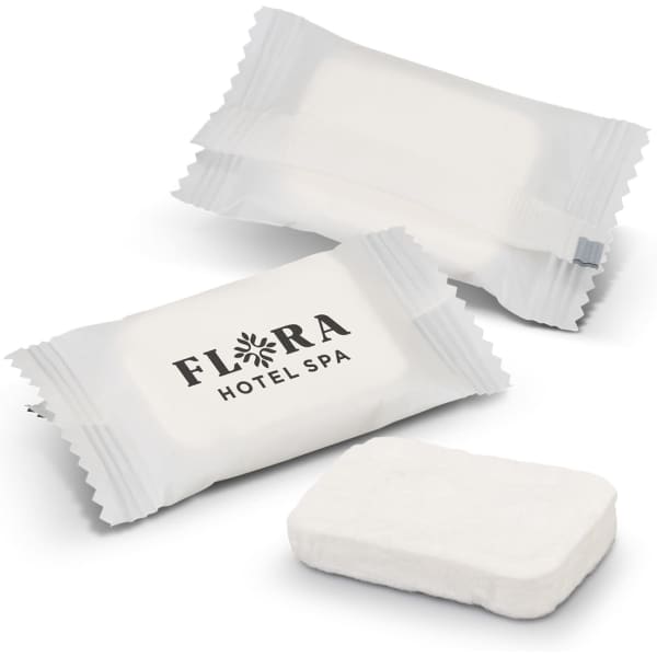 Compressed towels in white packaging, with an accompanying towel in a rectangular shape. One package features a logo.