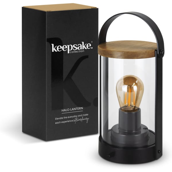 A glass and black metal lantern with a wooden lid, accompanied by its sleek black packaging featuring a logo.