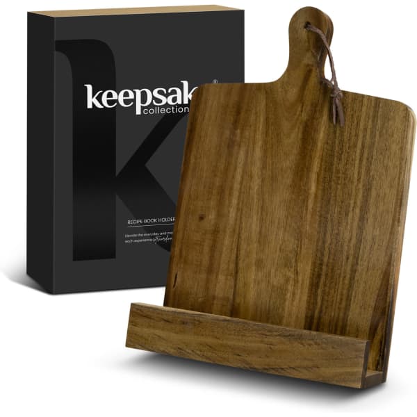 A wooden recipe book holder in a natural finish, presented with a sleek black packaging box featuring a logo.