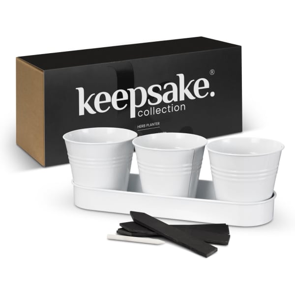 A white herb planter set featuring three pots, a matching tray, and wooden labels, presented in a black box with branding.