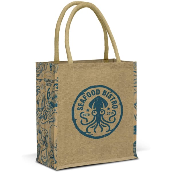 A jute tote bag in natural tan with blue decorative patterns and a circular logo on the front.