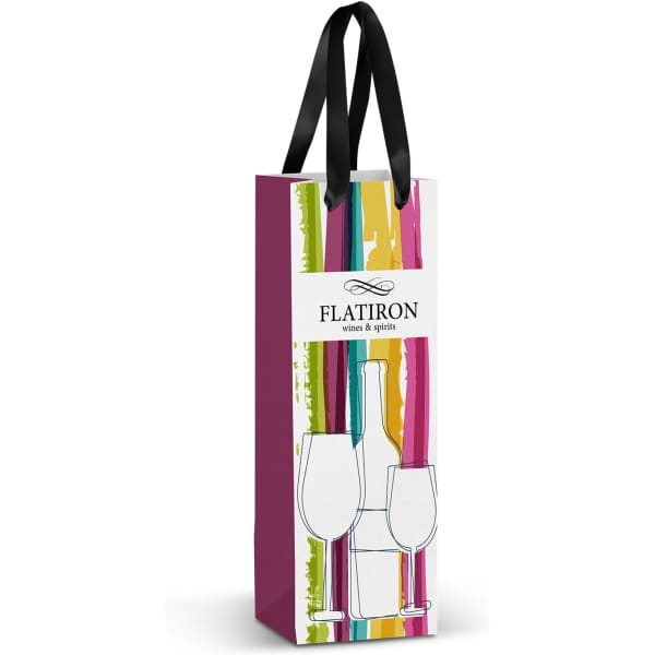 A full-colour paper bag in shades of pink, green, and yellow, with a black ribbon handle and a logo.