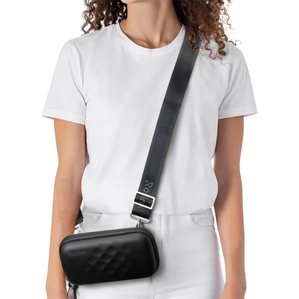 A black mini bag worn across the body, featuring a textured design and a long adjustable strap.