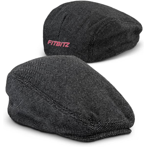 A flat cap in a black and grey herringbone pattern, featuring a logo on one side.