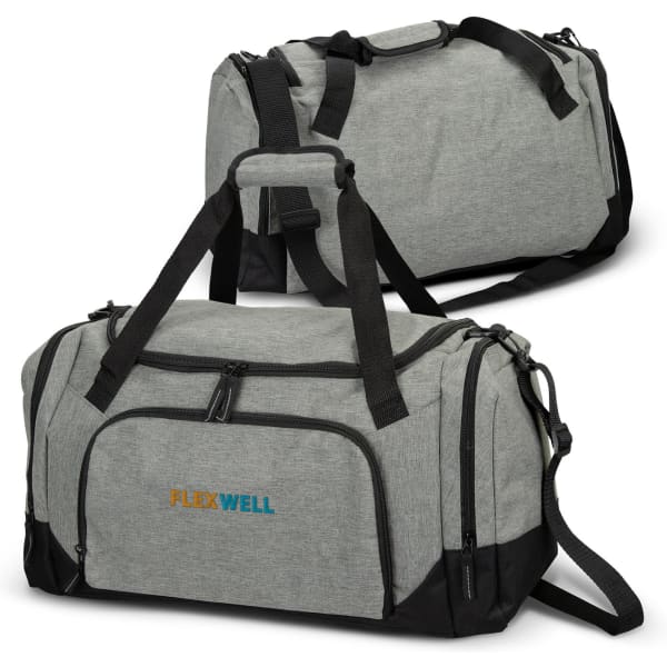A grey duffle bag with black accents featuring a logo, detailed with dual handles and an adjustable shoulder strap.