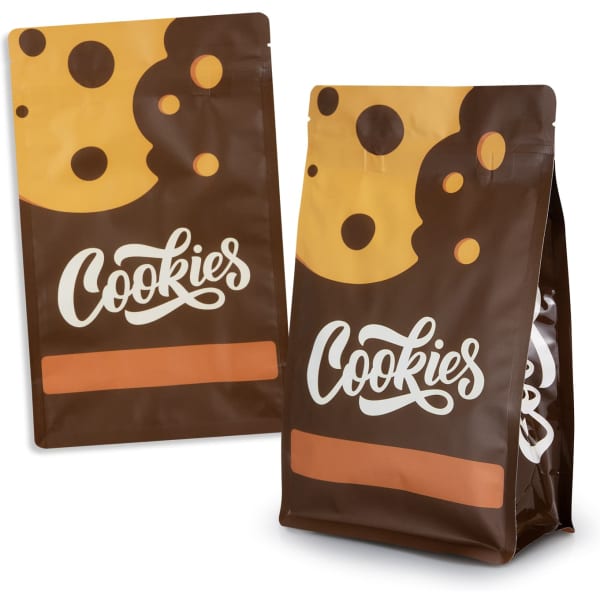 A small, brown foil flat-bottom pouch with a cookie pattern and logo, featuring a colourful design.