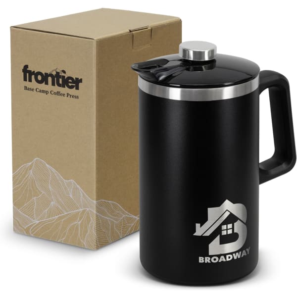 A black coffee press with a stainless steel lid sits next to a simple brown cardboard box, featuring a logo.