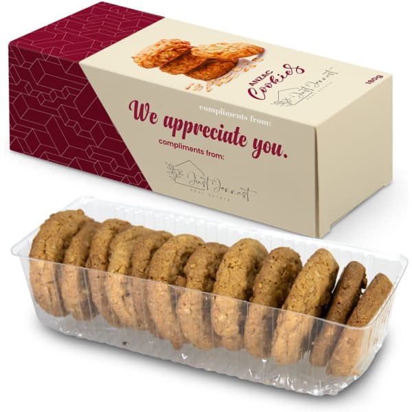 A boxed cookie pack featuring a clear container of golden-brown cookies arranged neatly inside.
