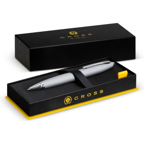 A silver ballpoint pen inside a black and yellow gift box, featuring a logo on the box.