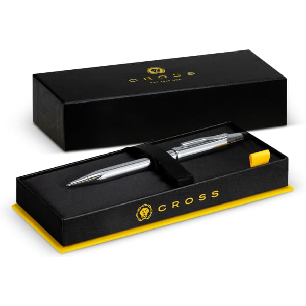 A silver ballpoint pen displayed in a black and yellow box with an embossed logo.