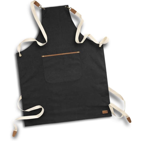 A black canvas apron with cream straps and a front pocket, featuring a small logo.