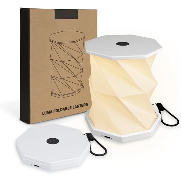A foldable lantern in white with a geometric design, packaged in a brown box with a logo.