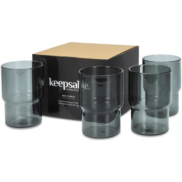 A set of four grey glass tumblers in a black packaging box, featuring a logo on the box.