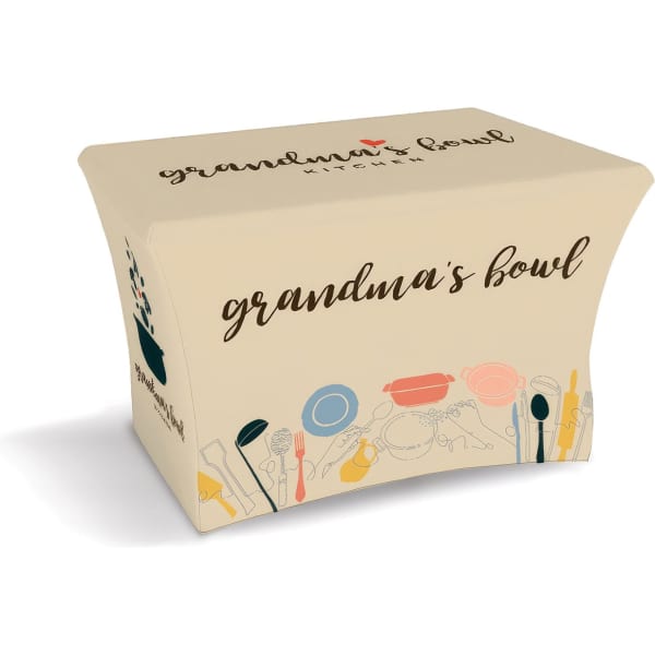A small stretched tablecloth in beige featuring a logo and kitchen utensil designs in various colours.