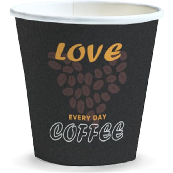 A black disposable paper cup with a heart made of coffee beans and text reading 