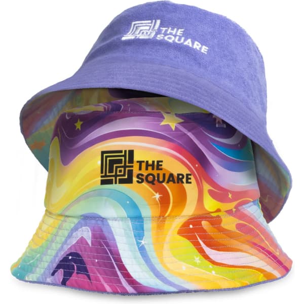 A custom reversible bucket hat featuring a purple terry side and a vibrant, multi-coloured swirled pattern on the other side.