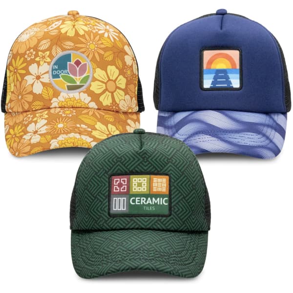 A collection of three caps featuring various floral and geometric patterns, with vibrant colours and branded patches.