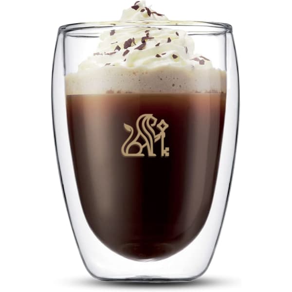 A double wall glass featuring a dark beverage topped with whipped cream and chocolate shavings. It has a logo on the front.