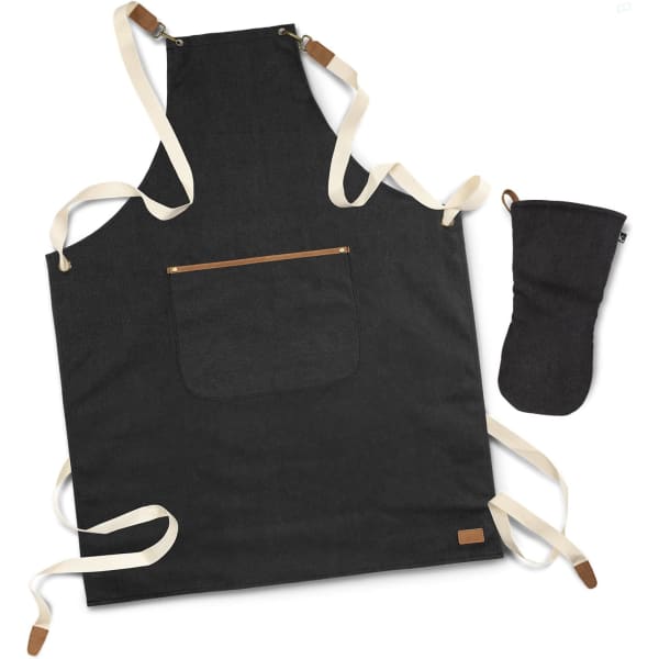 A dark grey canvas apron with cream straps and a matching oven mitt, featuring a pocket and a logo.