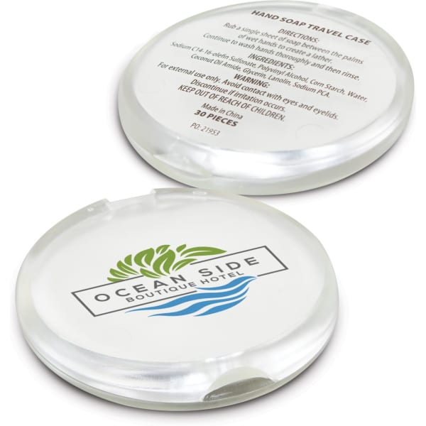 A round, transparent hand soap travel case with a green logo, featuring a list of directions and ingredients on one side.