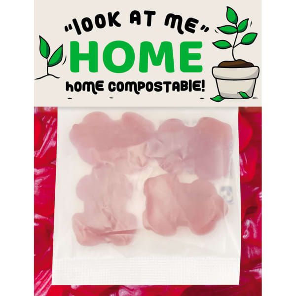 A pack of pink gummi lollies shaped like frogs, featuring a logo and compostable packaging.