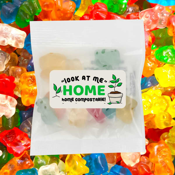 A packet of ECO Gummy Bears surrounded by colourful gummy sweets, featuring a cute logo and compostable message.