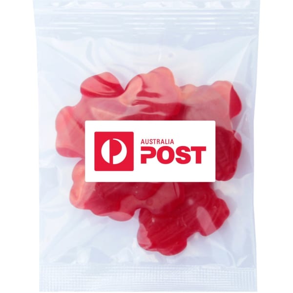 A packet containing red gummy lollies shaped like frogs. The bag features a logo.