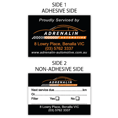 A set of rectangular labels with a black background, featuring orange and white branding, one side adhesive.