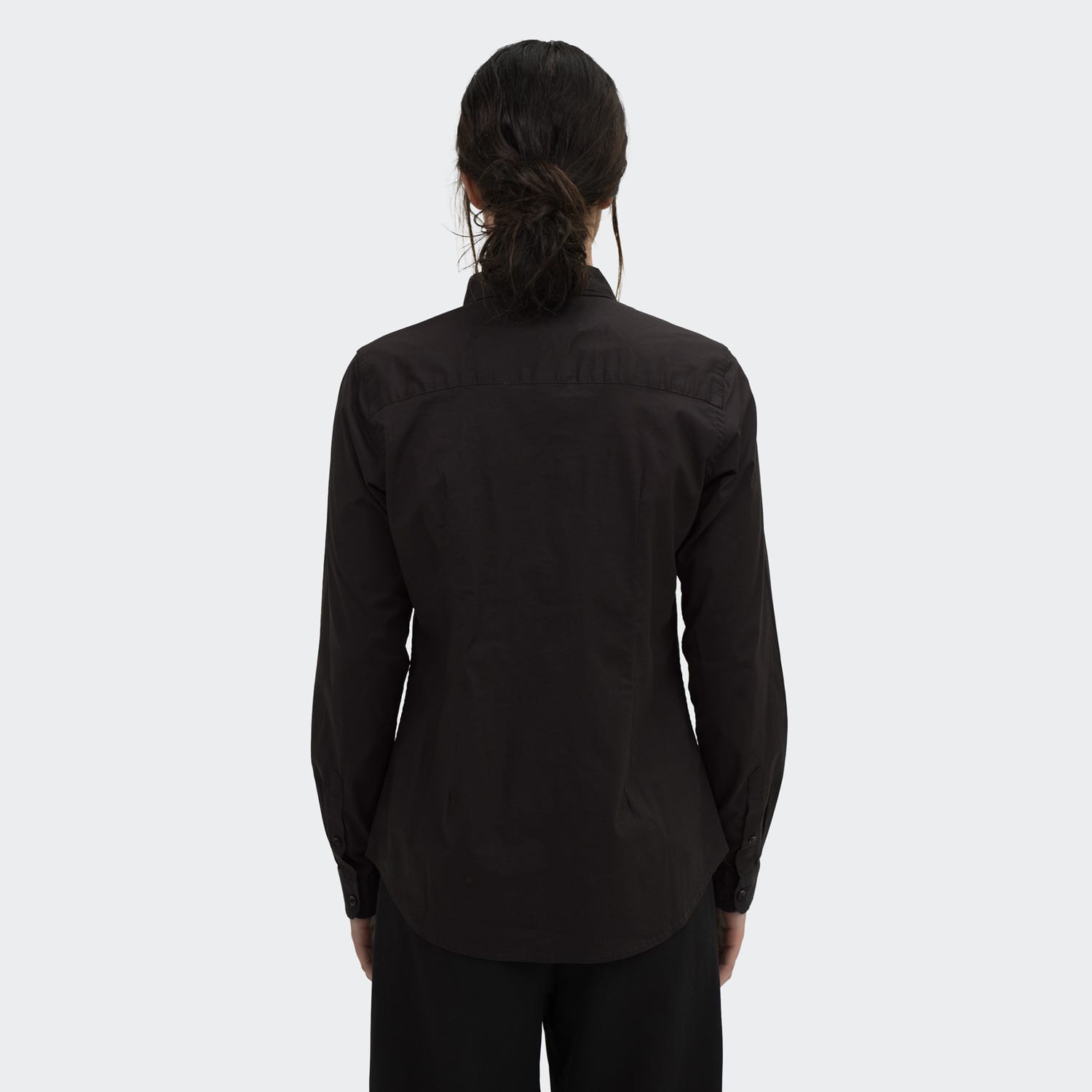 A women's black button-up poplin shirt featuring long sleeves and a fitted design, with a simple logo on the back.