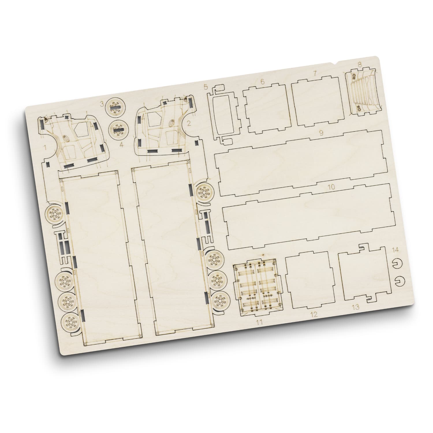 A wooden model kit featuring pre-cut pieces for constructing a large truck, displayed on a light wood board.