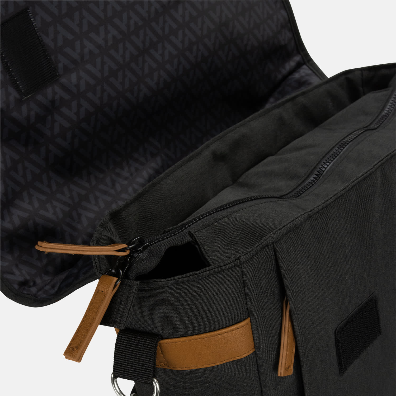 A grey messenger bag with brown accents, featuring an open zipper and a patterned interior. It has a branding logo.