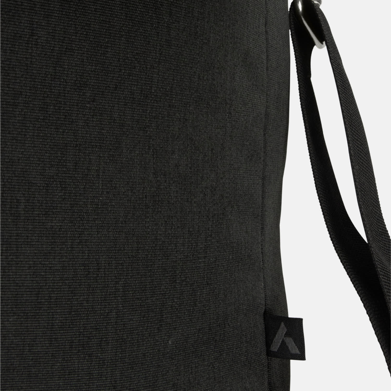 A black messenger bag with a textured surface, featuring an adjustable strap and a logo on the side.