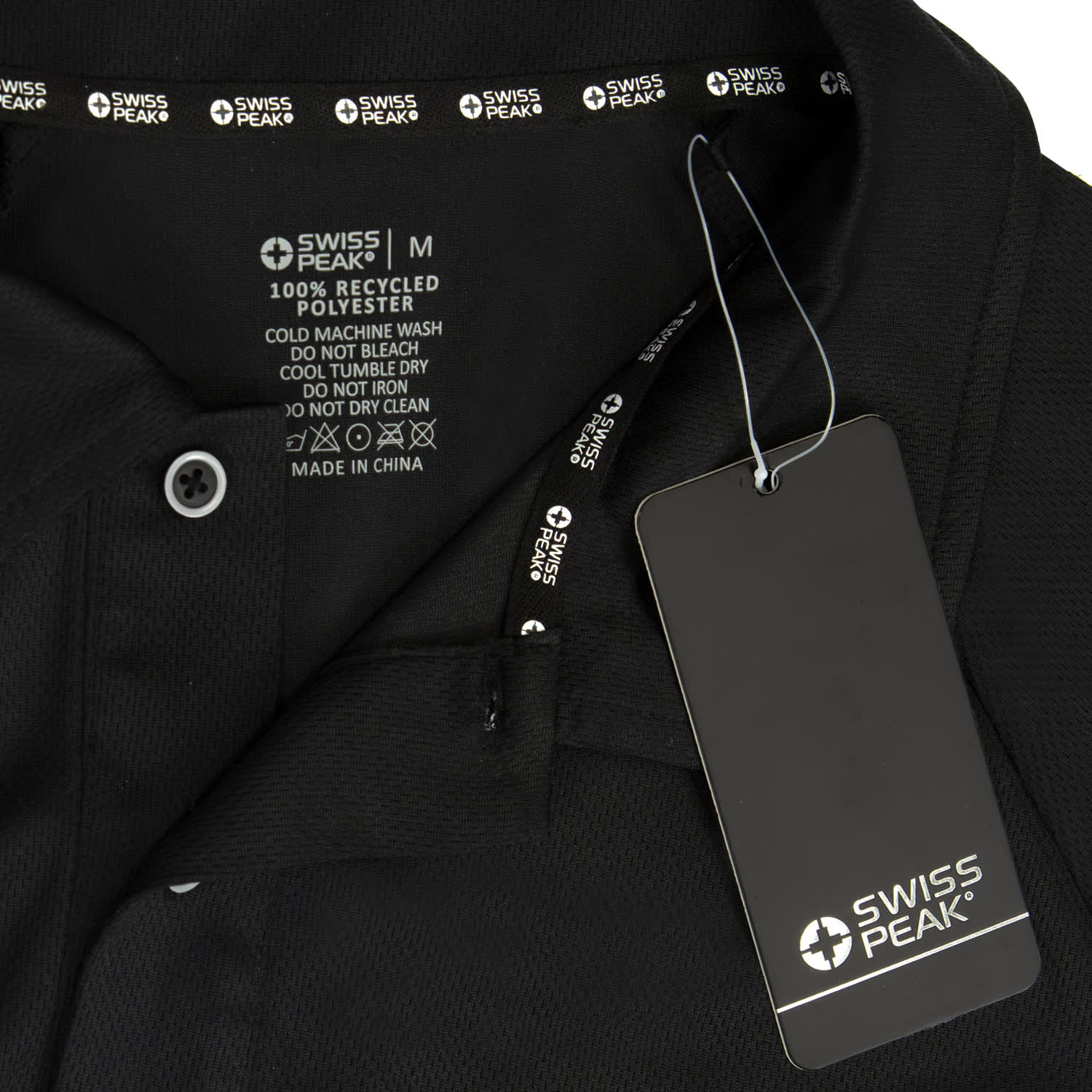 A black unisex polo shirt with care instructions and a tag, featuring a logo.
